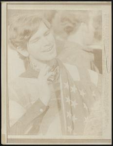Demonstrator Jon Hermanutz, Denver, shows his approval during anti Vietnam War demonstration at Civic Center here 4/15. Hermanutz, wore a wrap - the American Flag.