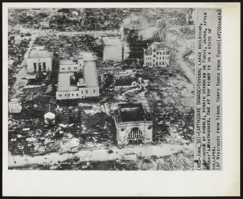 Earthquake Damage- Several large buildings, surrounded by rubble, remain standing in Fukui, Japan, after Monday's earthquake, One at top right is in a state of collapse.