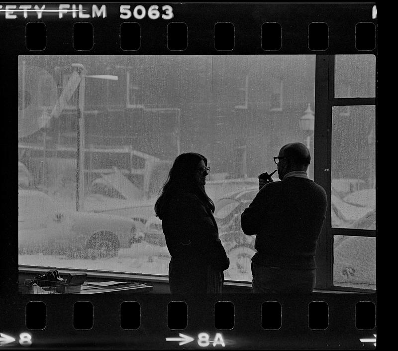 Two people in conversation during snow storm