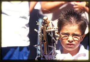 Boston - N. End 2002 - A boy holds a small statue of St. Anthony during St. Anthony's Feast