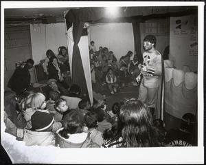 Costumed performer speaking to group of children