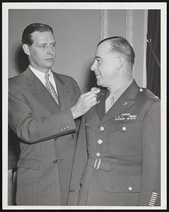 Govs Office. L-R. Gov Tobin pins star (denoting Brig. Gen) on shoulder of new adj Gen. Wm. H. Harrison