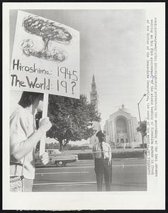 National Shrine: Pickets protesting the scheduling of the Luci Johnson wedding on the 21st anniversary of the atomic bombing of Hiroshima parade in front of the Shrine of the Immaculate Conception, the scene of the wedding.