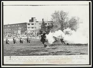 Toss Tear Gas-- National Guardsmen toss tear gas into rioters on Kent State University as demonstrators continues their protests.