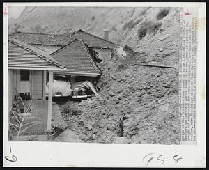 Cars Victim of Storm Landslides--Two cars in the garage of this hillside home owned by Marie Elizalde are victims of Southern California's severe storm as an avalanche of dirt hit the garage and compressed the cars. Occupants of the house had left earlier, when the deluge of water from the skies had loosened dirt on the near-vertical hillside.
