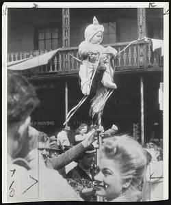 Improvised Box Seat-This youngster had no difficulty seeing the frolicking at the New Orleans Mardi Gras. His father fixed him up with an above-the-crowd perch.