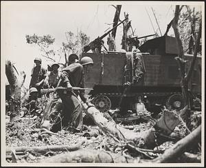 A marine-manned halftrack goes into action against enemy pillboxes on Peleliu