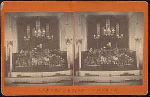 Man at pulpit of Congregational Church, surrounded by flowers