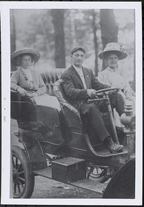 3 persons in early automobile