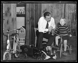 Jack Sharkey with his son, who is on a tricycle