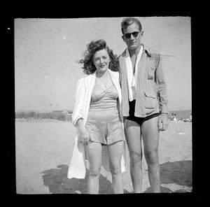 Man and woman in bathing suits on the beach