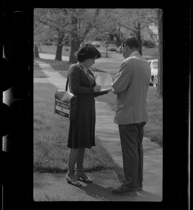 U.S. Census taker interviews man on street, Boston