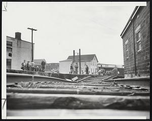 Washed Out Section of the Danvers branch of the B and M Railroad at Peabody, halted movement of two daily passenger trains and some freight traffic.