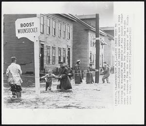 Life Lines Used to Evacuate Area--Police and rescue workers use a rope lifeline to evacuate the people of the Social Street area of this city before the Horseshoe Dam broke under pressure from the rising waters of the Blackstone River.