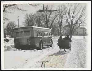 The Horse Comes Back--Scornfully ignoring a stalled bus, Old Dobbin trots along with his sleigh in the road to Providence.