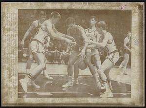 Follow The Bouncing Ball -- Galen Godbey (24), Boston College Forward, left, reaches out to recover loose ball between legs of Penn State University forward Jim Kissane (11). Action occurred in opening game of the 16th ECAC Holiday Basketball Festival today at Madison Square Garden. Boston College won, 87-58.