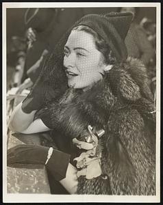 Mrs. Charles Ruffing watches her husband, Red, hurl the Yankees to an 3-1 victory over the Giants in the second game of the world series in New York City Oct. 7. A happy day for the Ruffing family, it was Red's first series win since 1992.