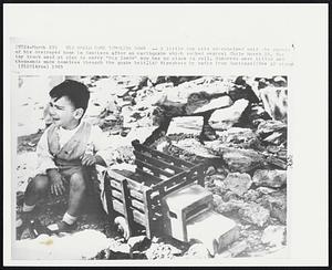 His World Came Tumbling Down -- A little boy sits overwhelmed amid the rubble of his destroyed home in Santiago after an earthquake which rocked central Chile March 28. His toy truck used at play to carry "big loads" now has no place to roll. Hundreds were killed and thousands made homeless through the quake belt.