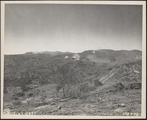 American M-4 and M-5 tanks fire from a Sicilian valley on a pillbox on hill, just before it fell