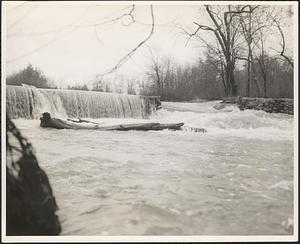 Breached dam on raging river