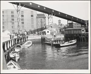 Men and boats at pier