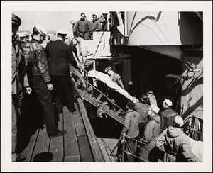 Eagle Boat (PE 56) blew up. Picture shows survivors picked up being taken ashore from DD at Grand Trunk Pier