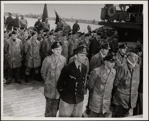 Officers (Foreground) and Crew (Rear) of the Surrendered U-1228 Stand on the Tug's Deck prior to Debarking at Portsmouth