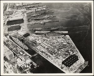 Aerial view of US Naval Dry Dock-BB-61 USS IOWA in dry dock #3-USS BUNKER HILL at East Jetty-AP-21 USS WAKEFIELD at pier