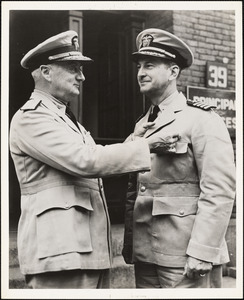 Capt. David H. Clark, USN, Planning Officer NYBos, with Commandant Rear Admiral Robert A. Theobald, USN