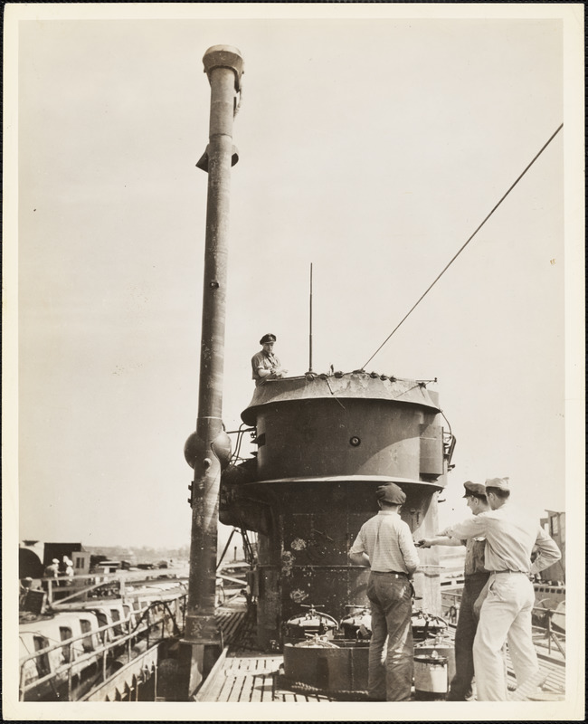Captured German sub is shown with "Schnorkle" pipe fully elevated