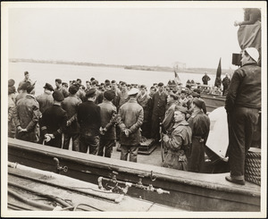 Officers and Crew on deck of tug which brought in surrendered sub U-873-man in white cap with hands behind back is Capt. Steinhoff