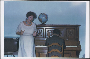 Faith (Phillips) Perera singing, accompanied by her husband Guido Perera on piano