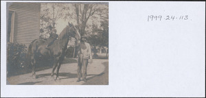 Guido Perera as a child on a horse with (probably) Tom Cook in the background