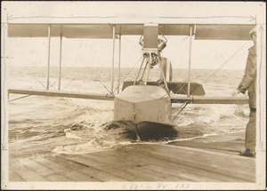 Curtiss Flying Boat at pier with unknown men