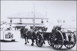 Antique fire engine in parade passing by Hyannis Depot