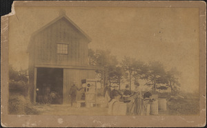 Cranberry barn with people and machinery