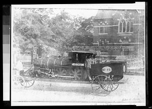 Parade float engine passing in front of Morse Institute Library