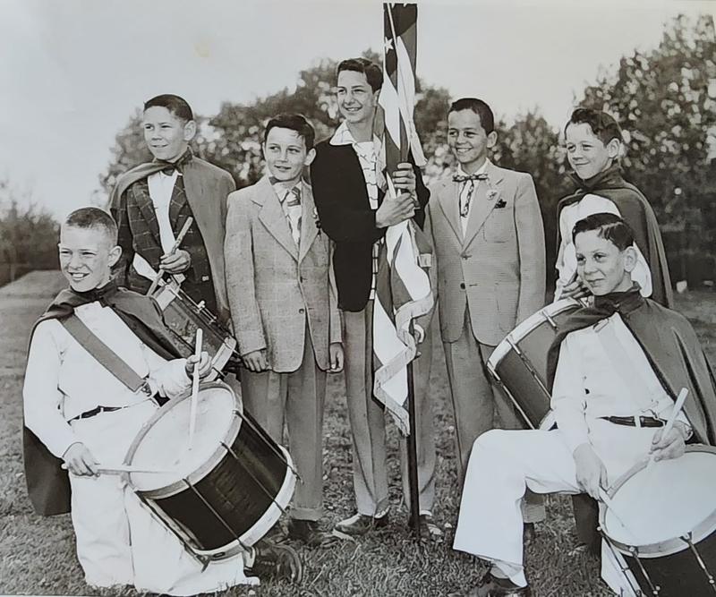 Four drummers and a flag bearer