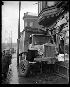 A & J Motor Lines truck which has hit a storefront