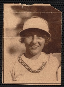 Unknown woman wearing sun visor and shirt and V-neck sweater