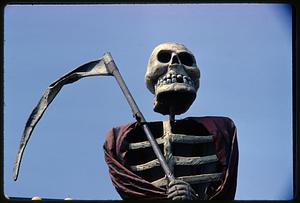 Skeleton figure holding scythe