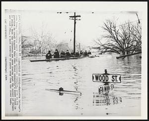Practice as Usual--Marietta College's crew team, defending small college national champion, gets in its practice as usual despite this Ohio River community's worst flood in 15 years. Here the Pioneers are seen rowing past the corner of Gilman and Wood Sts., a spot normally 50 yards away from the river bank.