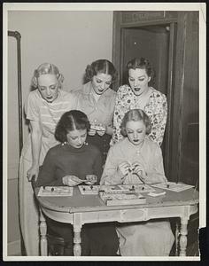 Here’s a new fad for turf-followers! Photo shows group of Bebe-Beri show girls playing new games called Parley-Mutual, while they wait for their next show to go on. The game has plenty of spills, thrills, daily double handicaps, steeplechases, etc.. It is played with parley-mutual make believe money, the horses have intriguing names, and a deck of ordinary playing cards is used. The game is already sweeping the country, particularly among stage and screen stars, and bids fair to his the peak of popularity already obtained by Monopoly.