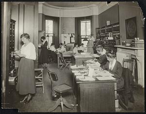 Volunteers in the office of the I.D.N.A. receiving calls and filing records.