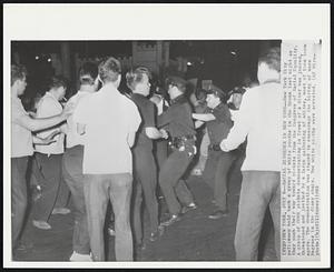 New York – Racial Disorder In New York – New York City policemen hold back a group of white youths in the Bronx last night as they push their way toward pickets from the Congress of Racial Equality. A group of CORE pickets demonstrating in front of a diner was jeered, threatened and jostled by a large gathering of whites, most of them teenagers. The demonstration was staged to encourage the hiring of more Negroes in the diner chain. Two white youths were arrested.