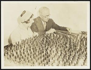 Milady's Beauty Paint. How many lips would a lipstick stick, if a lipstick could stick lips? Well, anyway-Ray Judd, left, and Max Factor inspect part of the million and a half lipstick which their Hollywood, Calif. Cosmetic Concern produces annually. Shades to fit every complexion are here, and whoever thought milady had so many complexions.