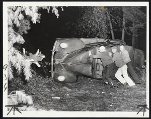 Car Upturned By Storm-These men struggle to right their automobile, overturned at Wareham in hurricane.