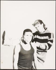 Two young people striking silly poses together