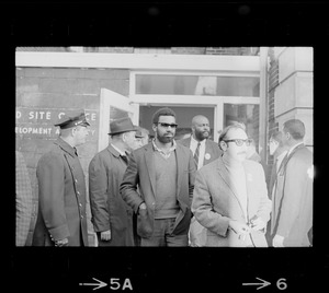 Man with dark glasses outside of Boston Redevelopment Authority office during BRA sit-in