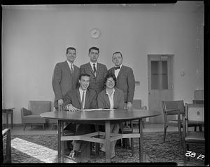 Five students behind a table